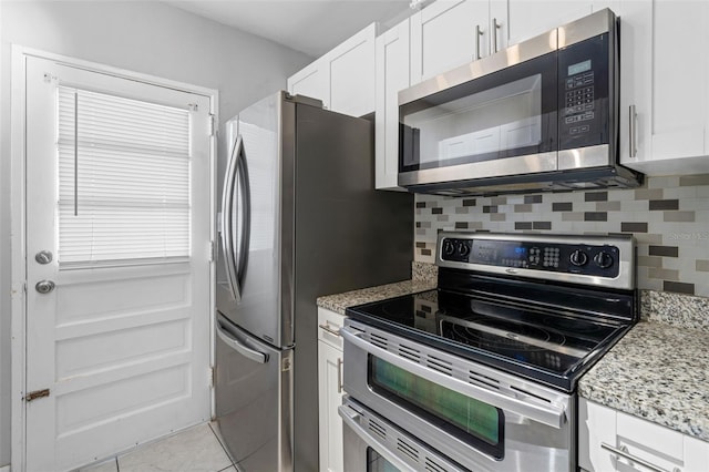 kitchen featuring light tile patterned floors, white cabinetry, and stainless steel appliances