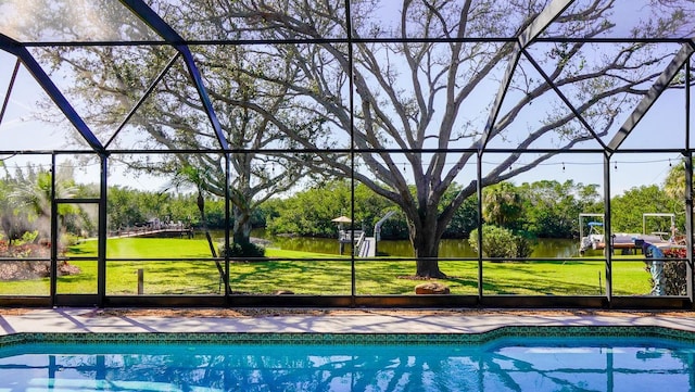 outdoor pool with glass enclosure and a yard