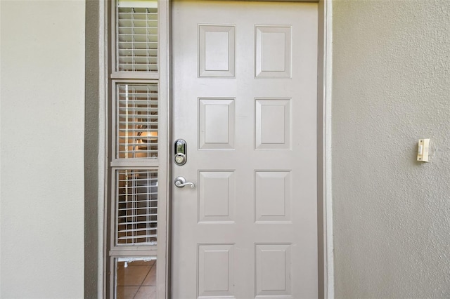 view of exterior entry featuring stucco siding