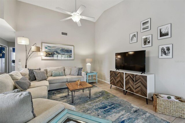 living room with high vaulted ceiling, visible vents, and tile patterned floors