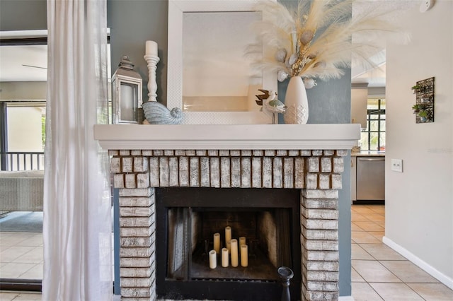 room details with a brick fireplace, baseboards, and stainless steel dishwasher