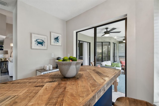 tiled dining space featuring visible vents