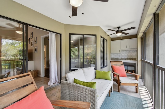 sunroom / solarium featuring ceiling fan