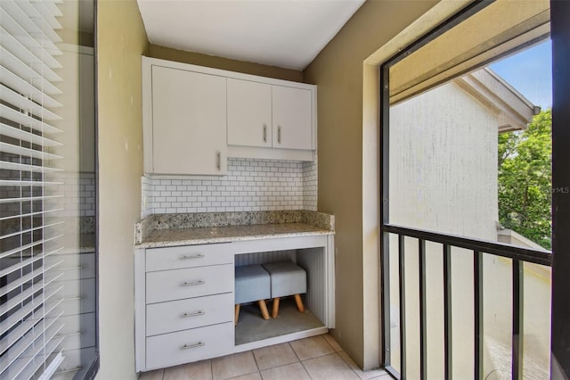 unfurnished office with light tile patterned floors