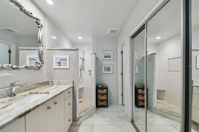 full bath with a stall shower, visible vents, vanity, and recessed lighting