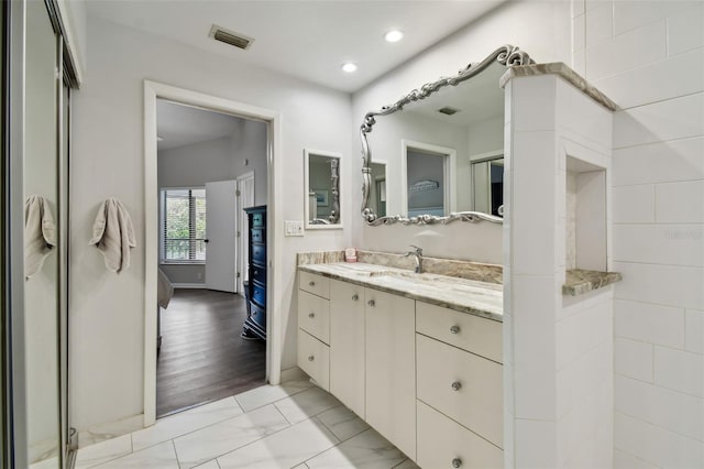 bathroom with recessed lighting, visible vents, and vanity