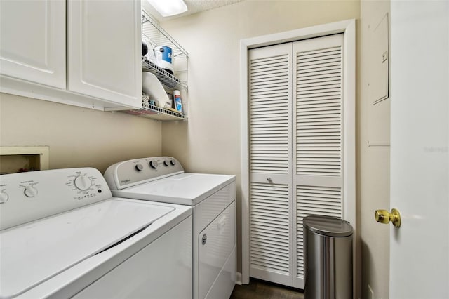 clothes washing area with washing machine and clothes dryer and cabinet space