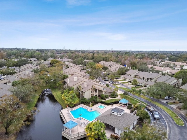 drone / aerial view with a water view and a residential view