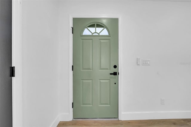 interior space with baseboards and light wood-style floors