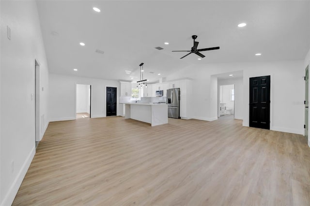 unfurnished living room featuring light wood finished floors, recessed lighting, ceiling fan, and vaulted ceiling