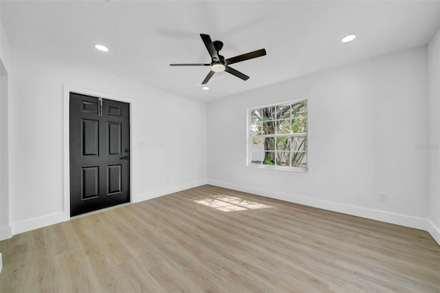 empty room featuring a ceiling fan, recessed lighting, wood finished floors, and baseboards