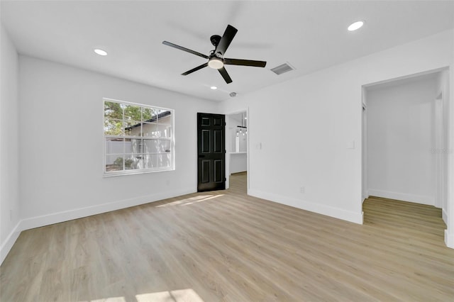 unfurnished room featuring recessed lighting, visible vents, light wood-style flooring, and baseboards