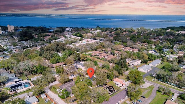 aerial view at dusk with a residential view and a water view