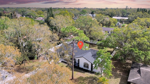 birds eye view of property with a view of trees