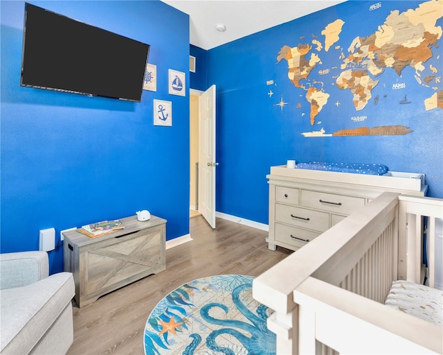 bedroom with wood finished floors and baseboards