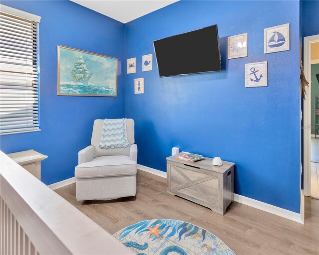 sitting room with wood finished floors and baseboards