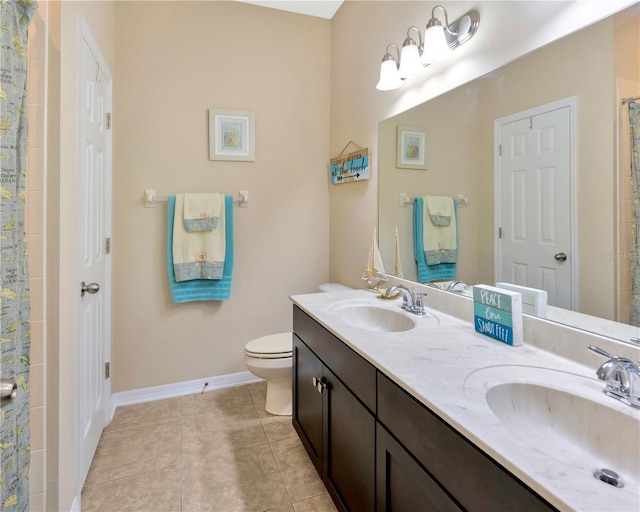 bathroom featuring tile patterned flooring, toilet, baseboards, and a sink