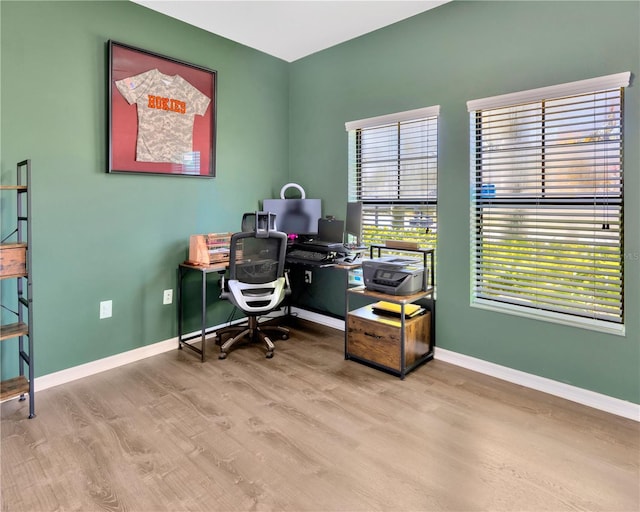 office area featuring baseboards and wood finished floors