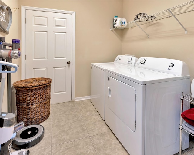 washroom with light tile patterned floors, independent washer and dryer, and laundry area