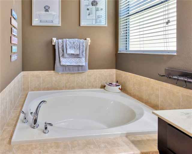 bathroom with a garden tub and vanity