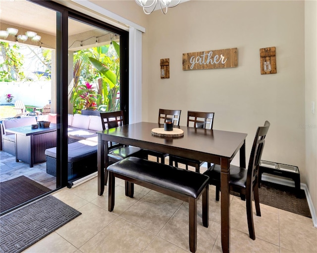 dining room featuring light tile patterned floors and a notable chandelier