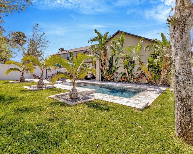 outdoor pool featuring a patio, a lawn, and a fenced backyard