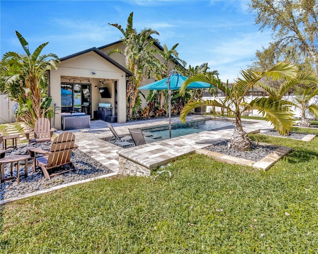 exterior space with a patio, an outdoor pool, and a hot tub