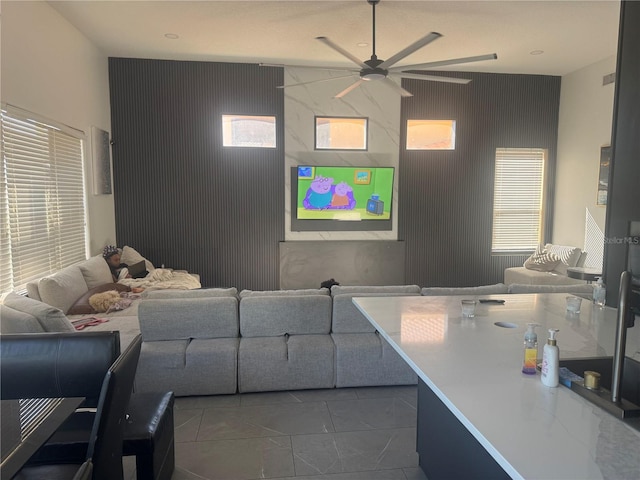 254 Chelsea Ave, Davenport, FL 33837 - living room featuring tile patterned flooring, an accent wall, and a ceiling fan