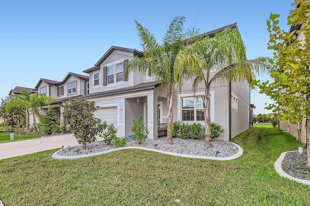 view of front of home featuring driveway, a front yard, a garage, and stucco siding