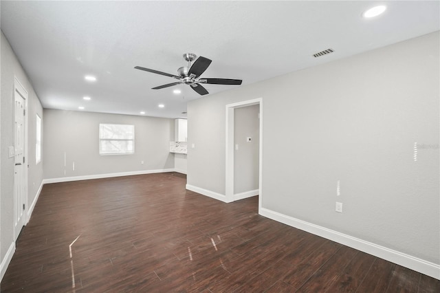 unfurnished living room with dark wood finished floors, recessed lighting, visible vents, a ceiling fan, and baseboards