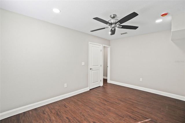 spare room with baseboards, visible vents, a ceiling fan, dark wood-style flooring, and recessed lighting