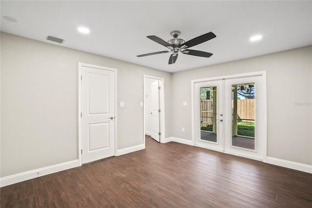 spare room featuring french doors, wood finished floors, visible vents, and baseboards