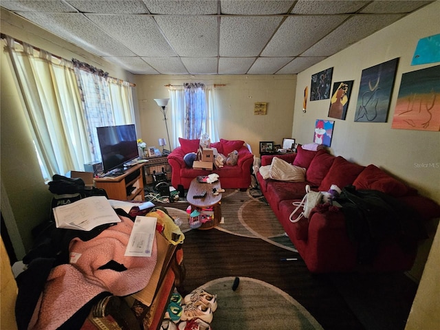 living room featuring a paneled ceiling