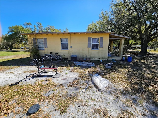 rear view of property featuring concrete block siding