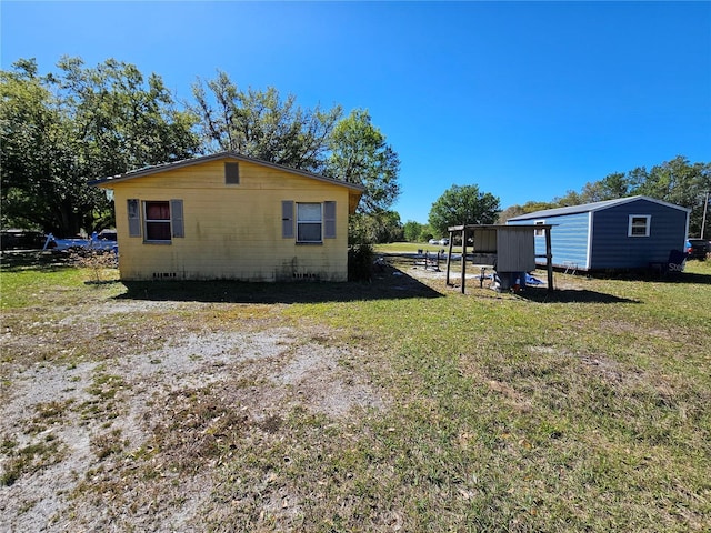 view of property exterior featuring crawl space and a lawn