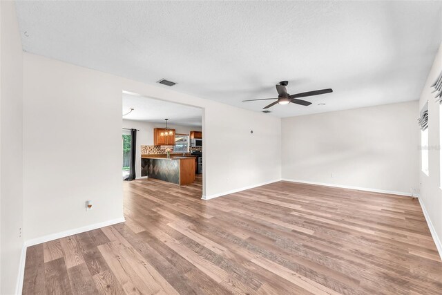 2412 Giddens Ave, Seffner, FL 33584 - unfurnished living room with a ceiling fan and light wood-type flooring