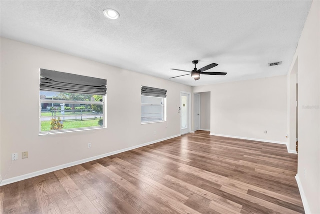 2412 Giddens Ave, Seffner, FL 33584 - spare room featuring a textured ceiling, wood finished floors, and ceiling fan