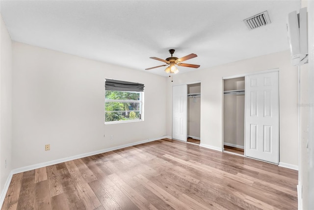 2412 Giddens Ave, Seffner, FL 33584 - unfurnished bedroom with multiple closets, light wood-style floors, and a ceiling fan
