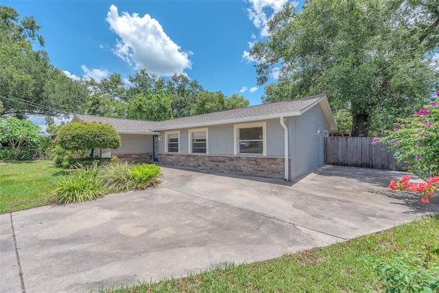 2412 Giddens Ave, Seffner, FL 33584 - ranch-style home with stucco siding, stone siding, and a patio
