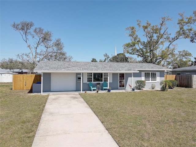 ranch-style house with a garage, brick siding, fence, concrete driveway, and a front yard