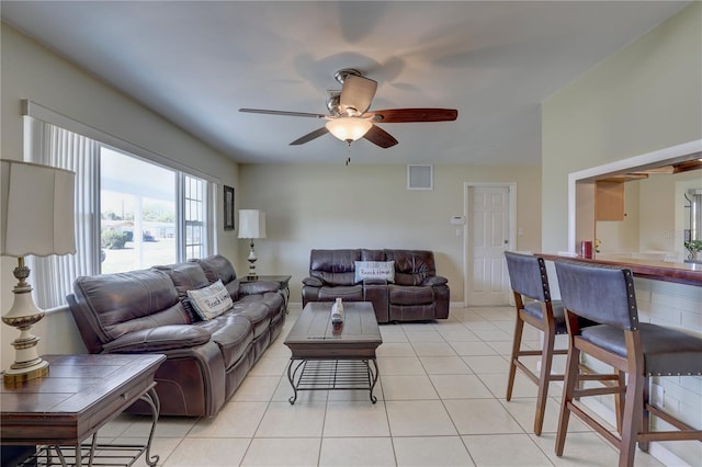 living area featuring visible vents, ceiling fan, baseboards, and light tile patterned floors