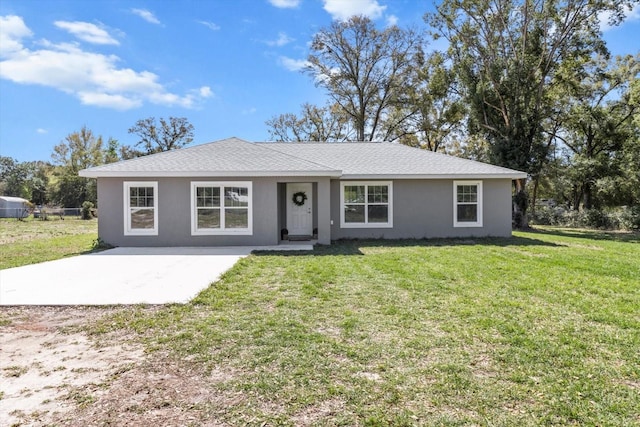 ranch-style home with a patio, a front lawn, a shingled roof, and stucco siding