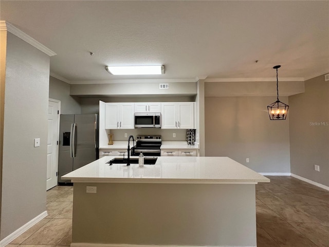 kitchen featuring appliances with stainless steel finishes, light countertops, white cabinets, and a sink