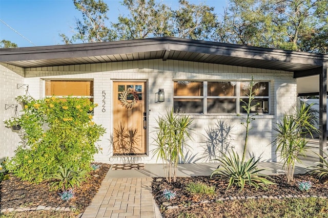 entrance to property with brick siding