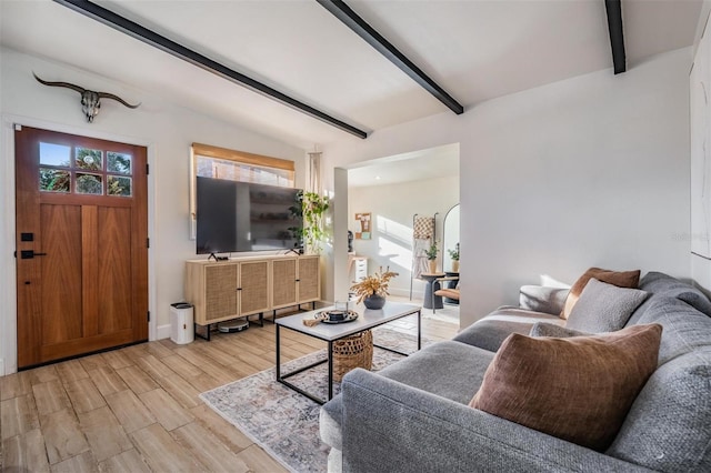 living room with light wood-type flooring and lofted ceiling with beams