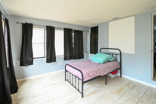 bedroom featuring visible vents and baseboards