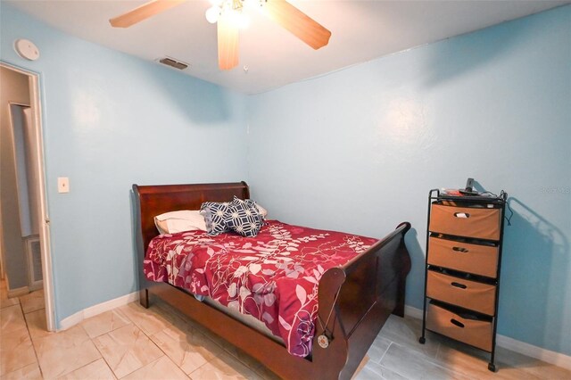 bedroom featuring a ceiling fan, visible vents, and baseboards