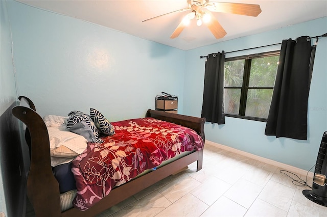 bedroom featuring baseboards and ceiling fan