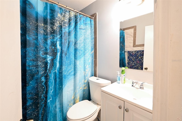 bathroom featuring a shower with curtain, toilet, and vanity