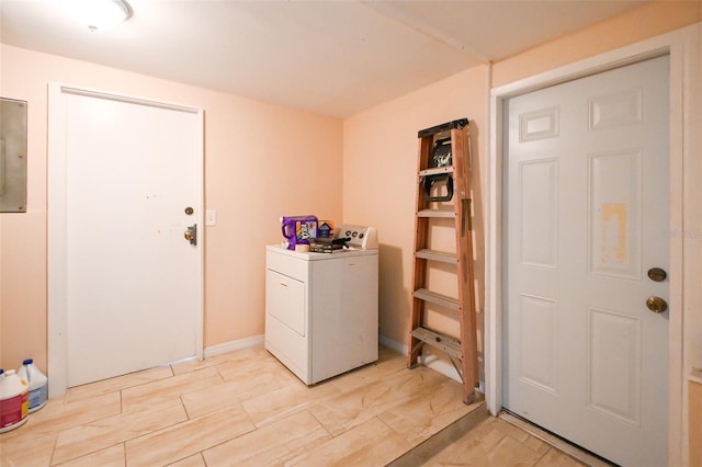 washroom featuring washer / dryer, electric panel, and laundry area